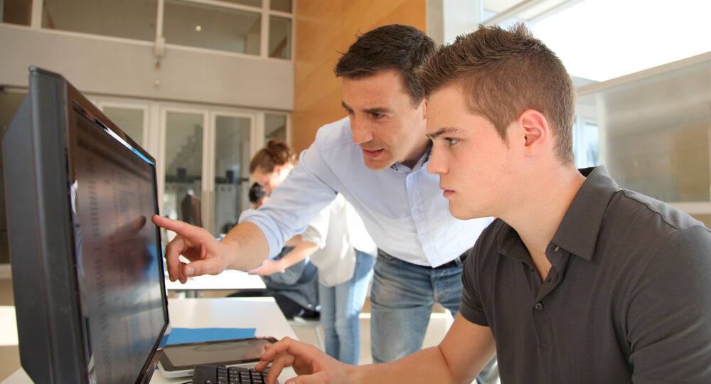 Teacher,And,Student,Working,On,Computer