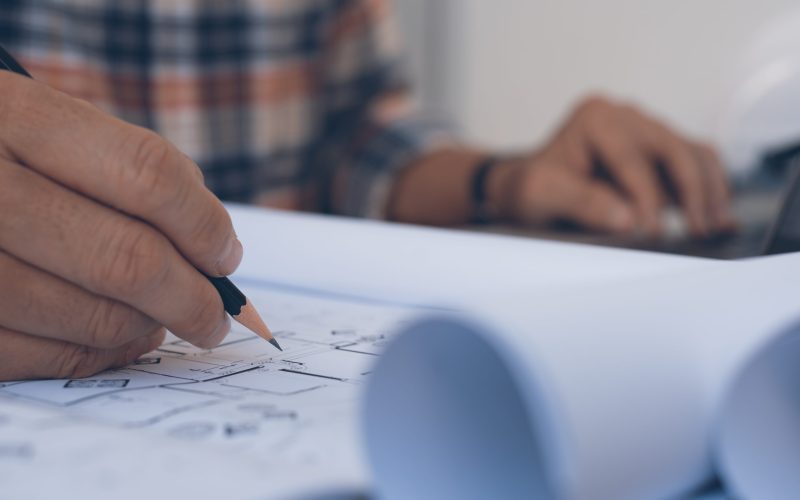 Close-up of annotating technical drawings with pencil